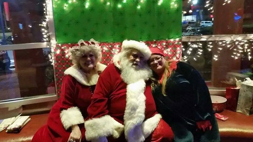 Santa, Mrs. Claus and an elf at a Give A Little Christmas event