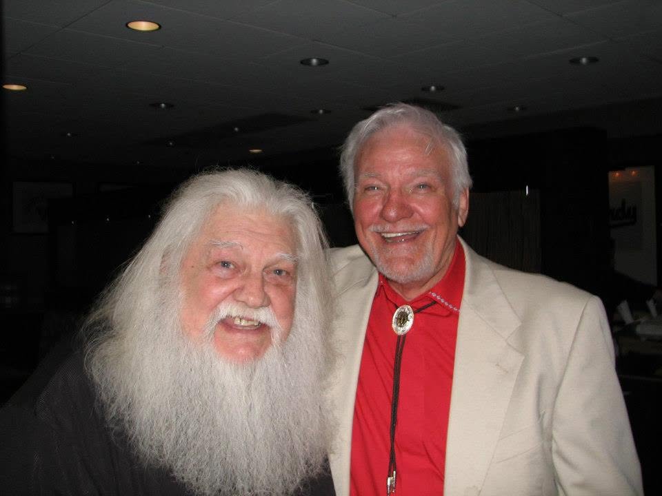 Jerry Foster smiling with a white-bearded friend backstage