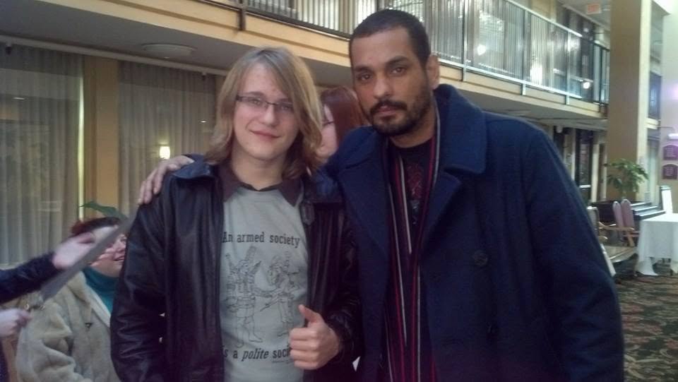 Robert Midgett giving a thumbs-up beside actor Santiago Cirilo at a convention