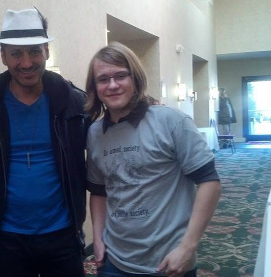 Robert Midgett posing with actor Cas Anvar at a convention