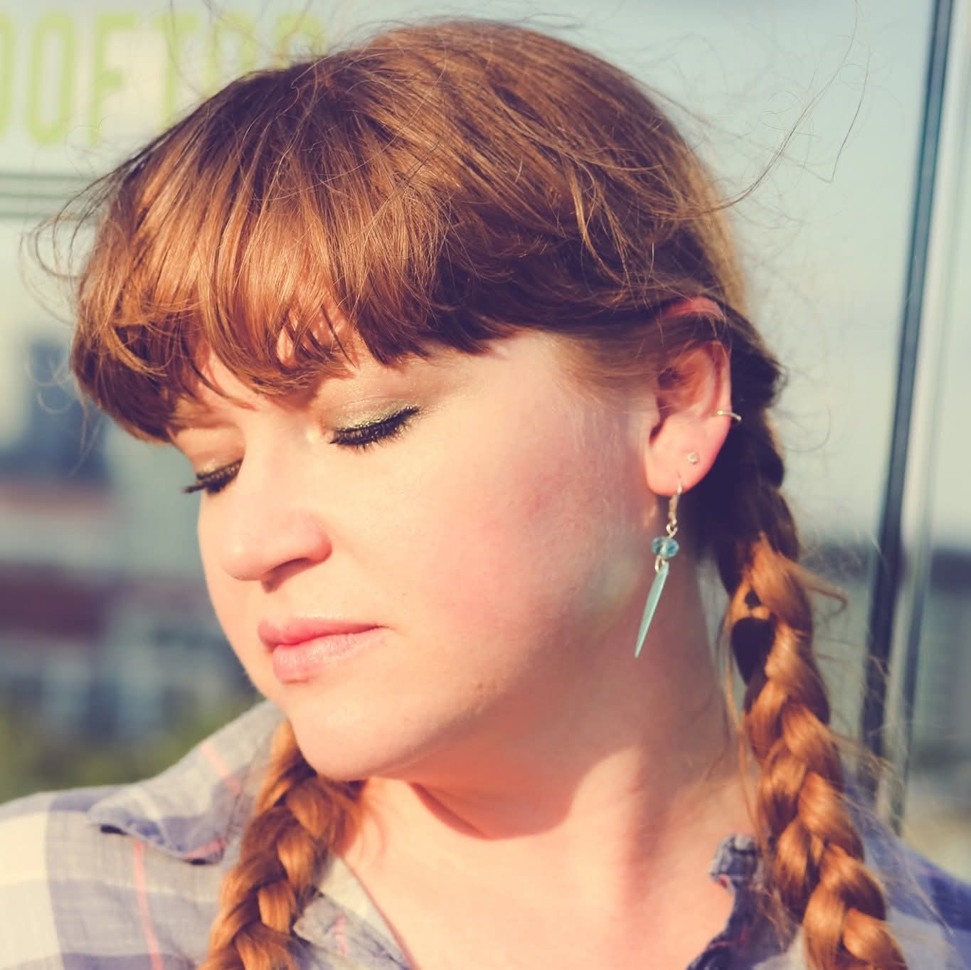 Olivia West in braids on a sunny Nashville rooftop